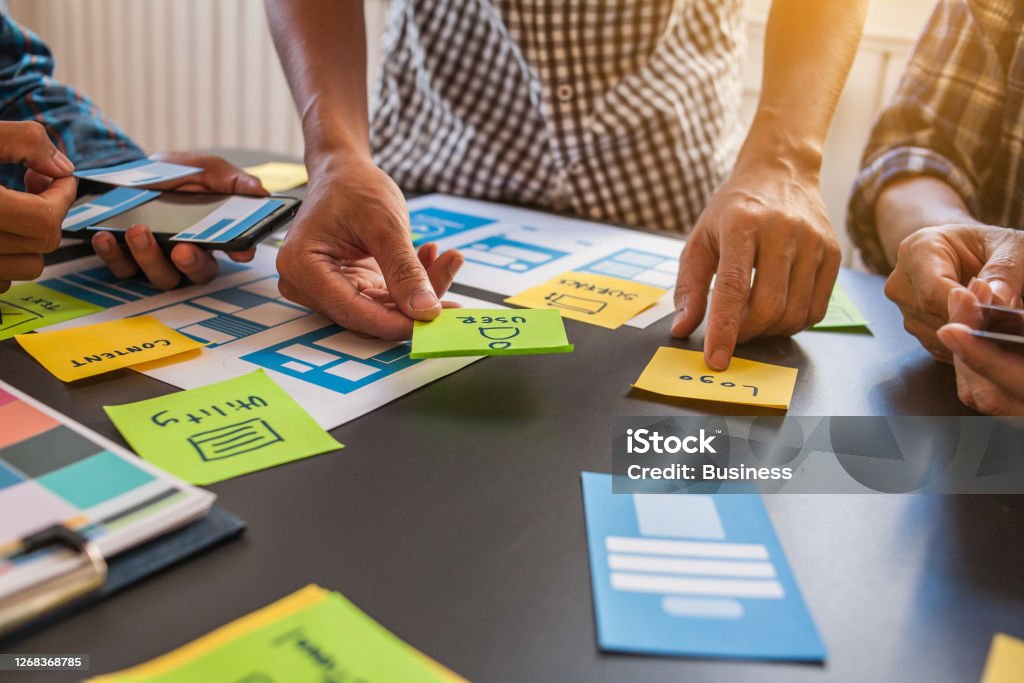 The web designer team is helping to design applications for mobile phones. UX UI designer concept Prototype Stock Photo