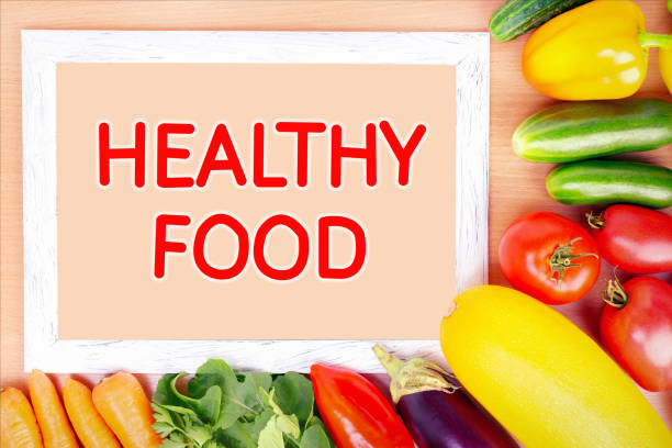 istock Healthy food concept. Assorted vegetables and frame on wooden surface. 1268370884
