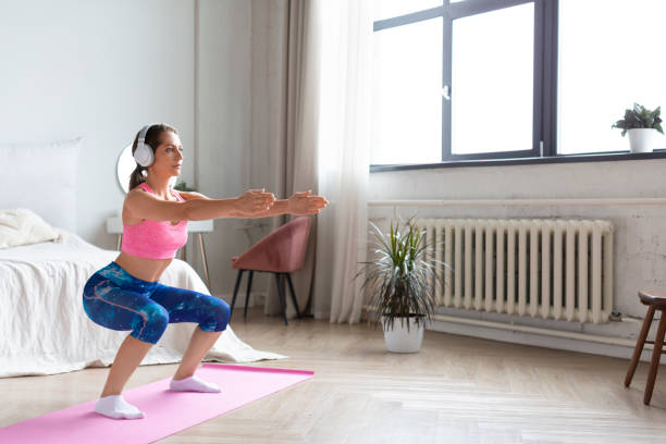 istock Young attractive woman workout at home 1268371819