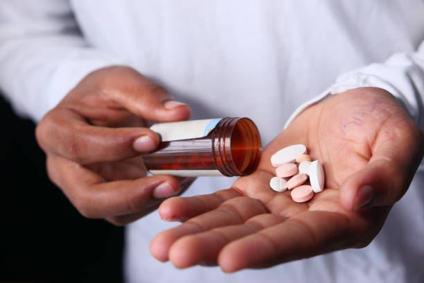 istock Close up of man hand taking medicine 1268374723