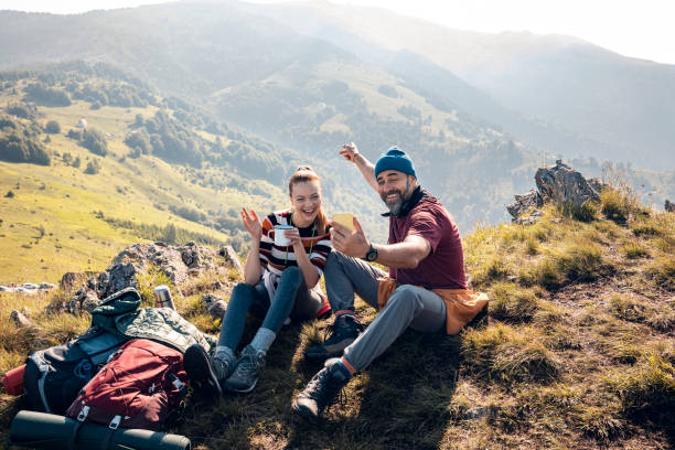 istock Young couple taking a selfie while out camping 1268379626