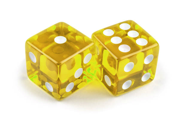 istock Two yellow glass dice isolated on white background. One and six with a shadow. 1268381384