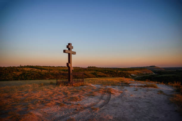 istock Wooden cross on the mountain at sunset 1268384961