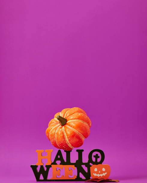 istock Happy halloween decorations on purple background 1268385883