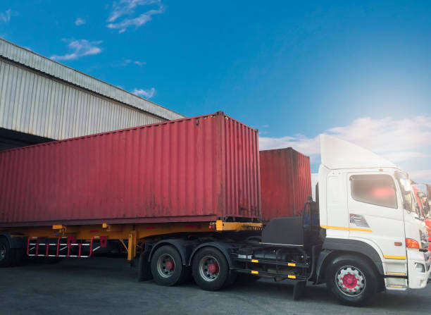 istock Cargo freight transportation, Shipment, Delivery service. Container truck docking load cargo at distribution warehouse. 1268389158