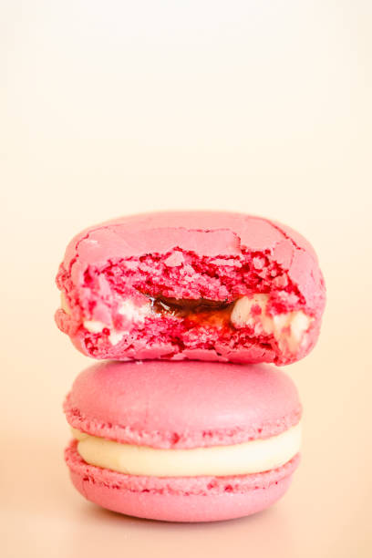 istock Two pink macaroons in a stack, one of them bitten off. 1268390919