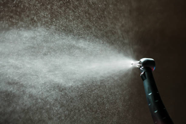 istock dental diamond cylinder bur with hand-piece and water spray. 1268391472