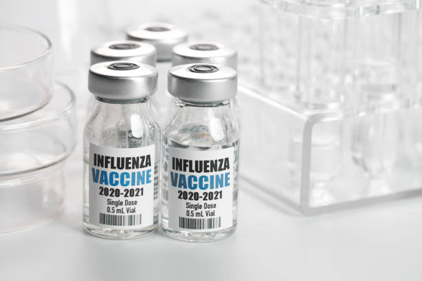istock Influenza Flu Vaccine in bottles with syringe on white background 1268393468