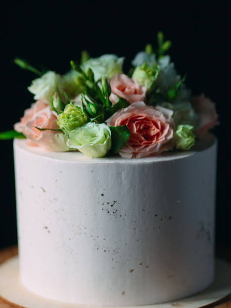 istock Cake is decorated with flowers on a dark background. 1268393480