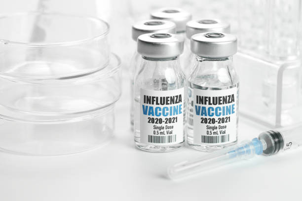 istock Influenza Flu Vaccine in bottles with syringe on white background 1268393817