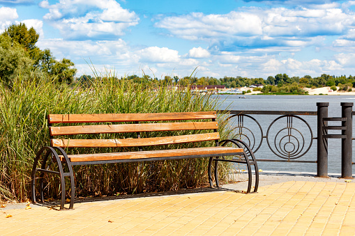 A public bench with a view over the water in a public park in Ishøj a suburb south of Copenhagen.