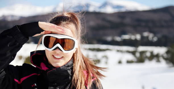 istock Woman wearing ski goggles looking at distance 1268394568