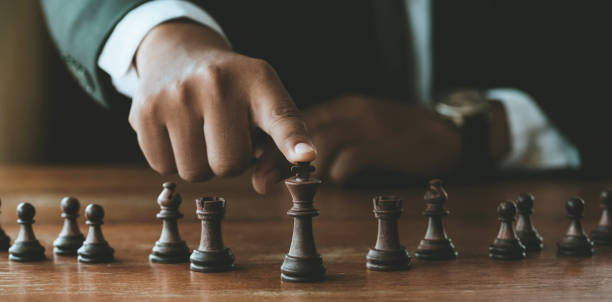 istock businessman hand control chess play figure business strategy manage ideas concept 1268396906