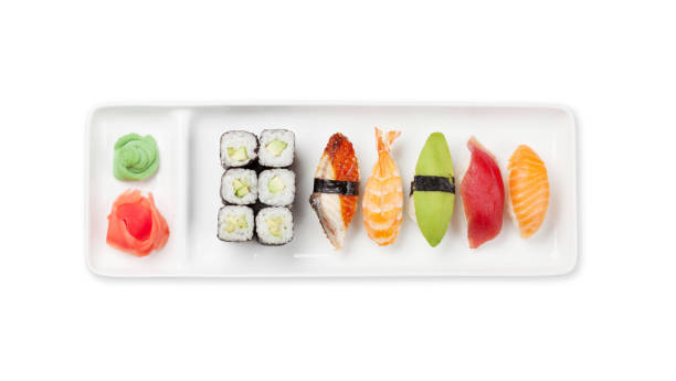 Japanese sushi set. Sashimi, maki rolls on plate Japanese sushi set. Sashimi, maki rolls on plate. Top view flat lay isolated on white background maki sushi stock pictures, royalty-free photos & images