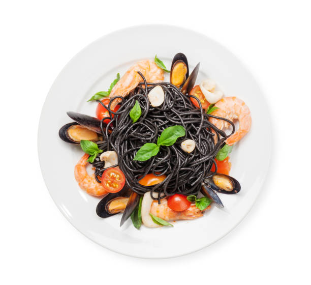 Black spaghetti pasta with seafood, tomatoes and basil