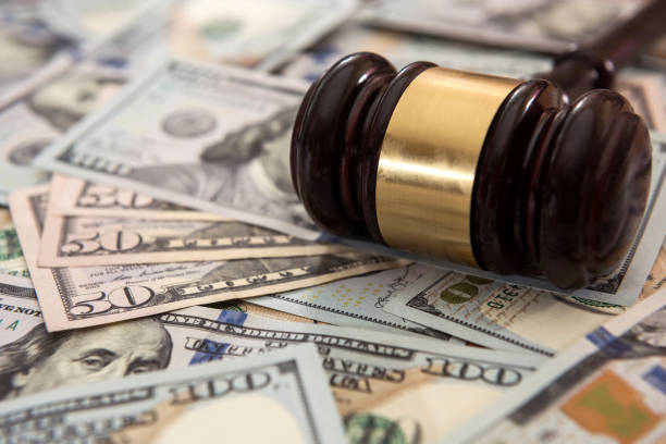 istock Wooden gavel and dollar bills in justice concept 1268401465
