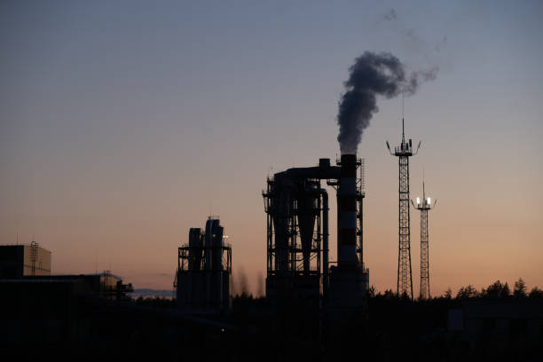 istock Factory pipe polluting air against sunset, environmental problems, smoke from chimneys. 1268403057