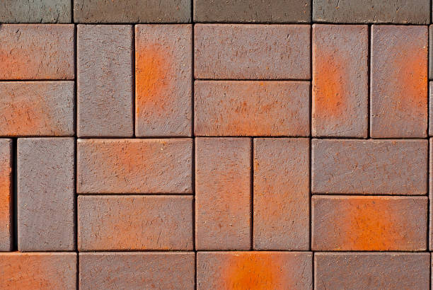 istock Cobblestone texture. The sidewalk tile is evenly folded. Brown and orange cobblestones close up. 1268403306