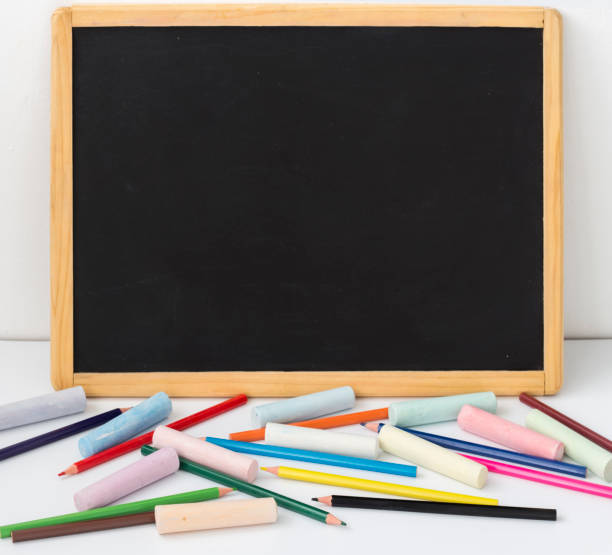 istock drawing Board with pencils and crayons on a white background with a copy of the space 1268404449