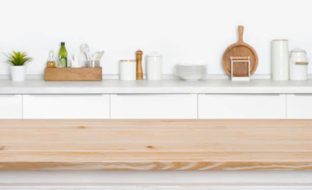 Board in front of kitchen countertop with utensils and spices
