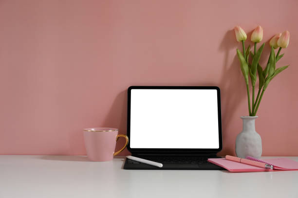 istock Copy space tablet with a white blank screen is putting on pink workspace. 1268404817