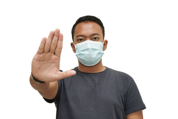 istock Portrait of a young man using mouth mask 1268404834