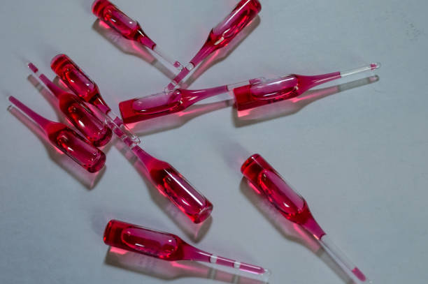 istock Production of medicines. Red ampoules on grey background. 1268405928