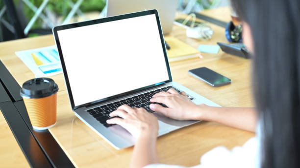 istock Cropped image of woman using an empty screen computer laptop. 1268406261