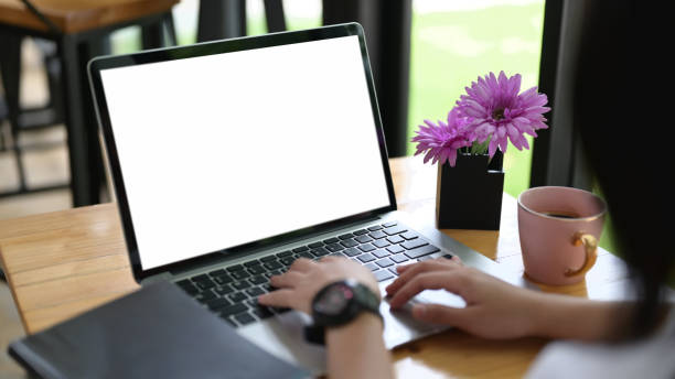 istock Cropped image of the hand is using an empty screen computer laptop at the wooden working desk. 1268406790