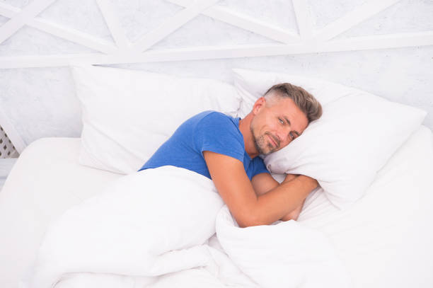 istock Man handsome guy lay in bed. Its bed for me. Young man sleeping on bed. Need some rest. Morning inspiration. Lucky to start the day here. Early morning. sleepy man in bedroom. Wake up Sleepy 1268414513