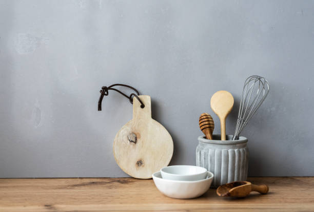 istock Kitchen utensils on a wooden table against a gray background 1268415745