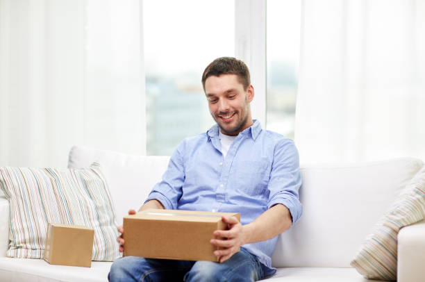 istock happy man with cardboard boxes or parcels at home 1268415877