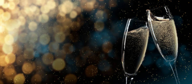 Christmas and New Year greeting card with champagne Christmas and New Year wide bokeh backdrop. Xmas greeting card template background with champagne glasses and copy space celebratory toast stock pictures, royalty-free photos & images