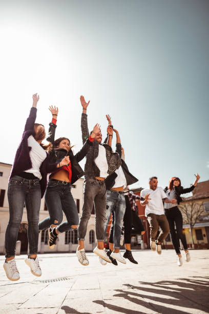 istock happiness group of friends with arm raised 1268420267