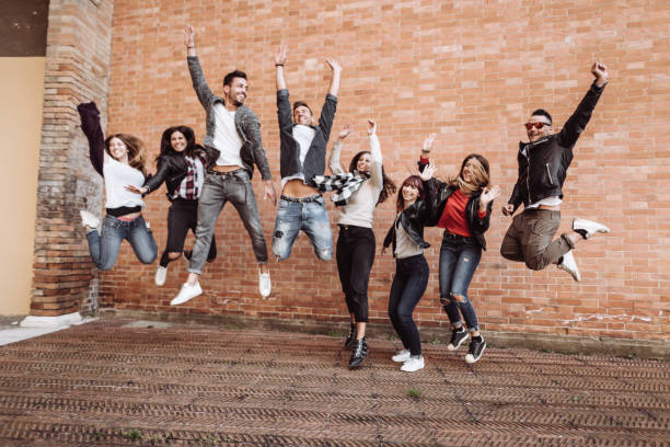 istock happiness group of friends with arm raised 1268420302