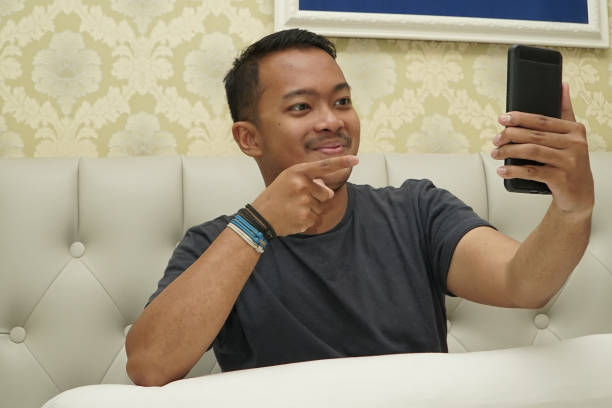 istock Happy Man Video Call on the Smartphone at Home 1268422007