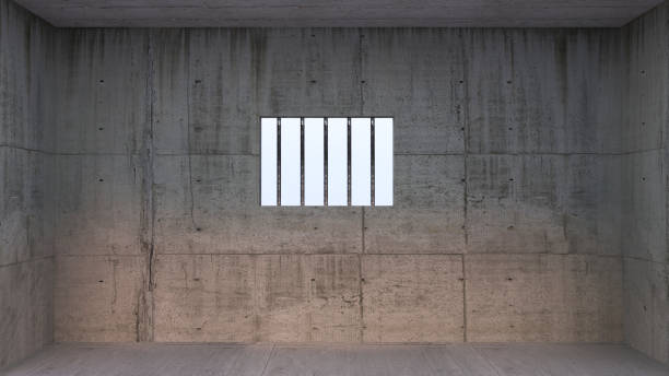 istock Prison cell with light shining through a barred window -  inside jail barrier, 1268422288