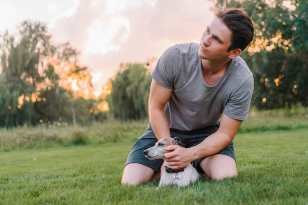 istock Man playing with senior Jack Russel terrier 1268423125