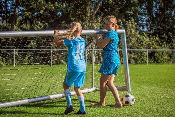 young girl playing soccer outside