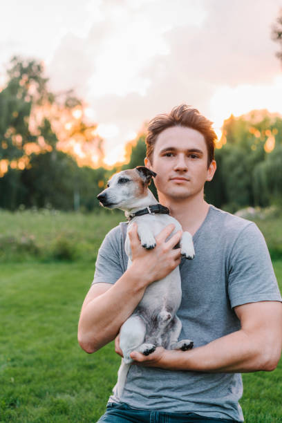 istock Man playing with senior Jack Russel terrier 1268424457