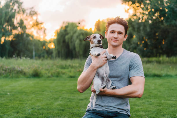 istock Man playing with senior Jack Russel terrier 1268424460