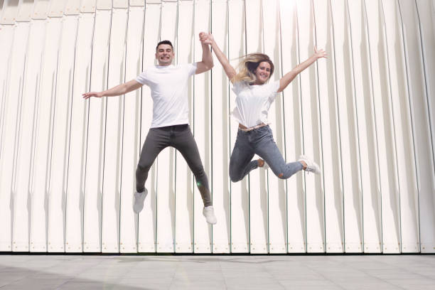 istock Young happy infatuations jumping while holding hands 1268430733