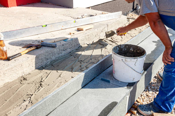 Installation of granite stairs A worker is assembling exterior granite stairs concrete step repair stock pictures, royalty-free photos & images