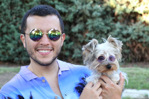 Man and dog wearing sunglasses.