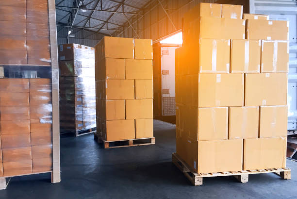 istock Road freight cargo delivery by truck. Stack of shipment boxes waiting for load into container truck at warehouse dock. Logistics and transportation 1268433188