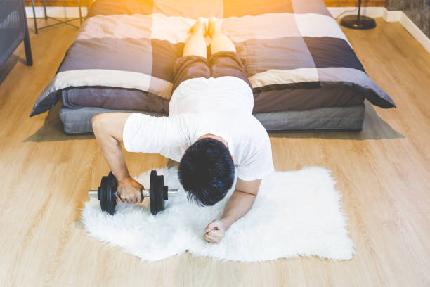 istock asian man exercising on bed in the morning 1268433582