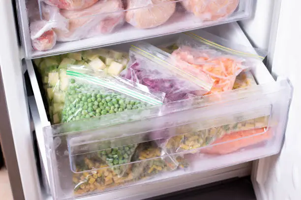Assortment of frozen Vegetables in home fridge. Frozen food in the freezer