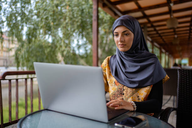 istock Muslim businesswoman working from cafe 1268435307