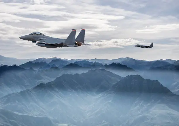F-15 Eagle Fighter Jets flying over fogy mountains