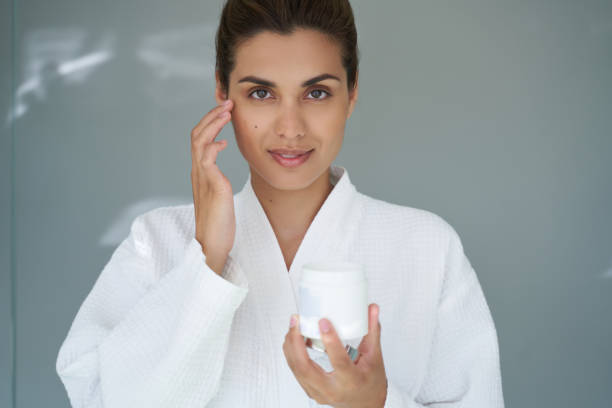 istock Confident attractive lady using beauty products for face 1268438706